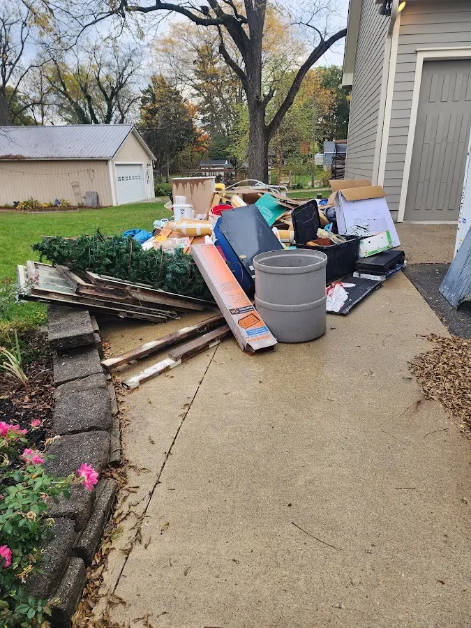 Dumpster being loaded with debris for Estate Cleanout Dumpster Rental in Azle